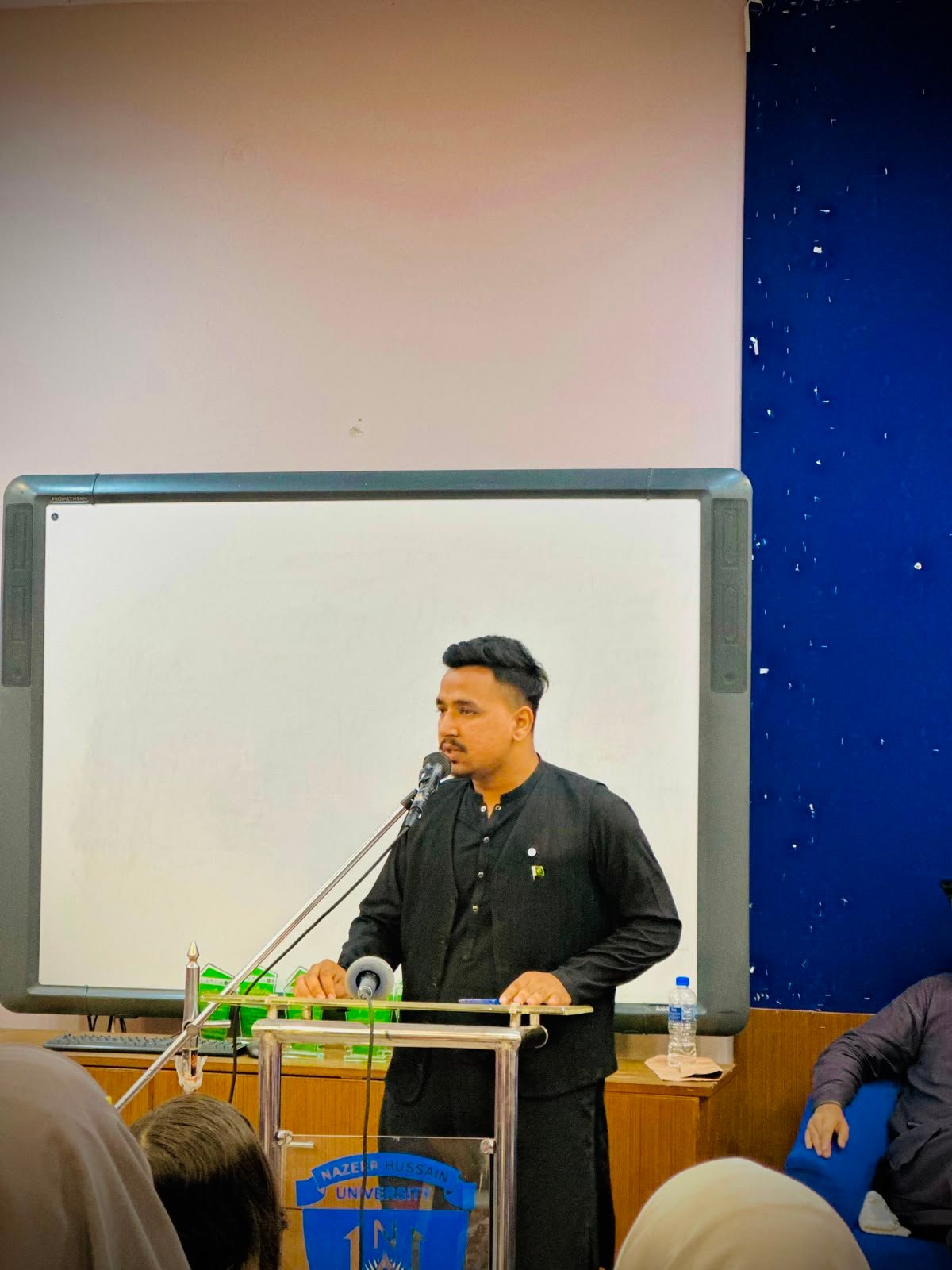 Syed Qadar Shah speaking to students during a university session
